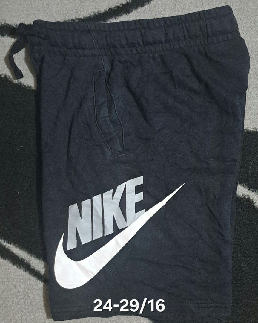 Nike Black Shorts Size M (Category: Shorts) located in San Fernando, Camarines Sur. Submitted by ladderaya (Listing ID 1470241437, Image 1). Description: - Brand: Nike - Color: Black - Size: Youth Medium (fits heights 140-150cm) - Design: Large grey & white Nike logo on left leg - Features: Adjustable drawstring waist with side pockets - Material: 80% cotton, 20% polyester blend - Style Code: CK0509-010 - Condition: Clean with tags attached.