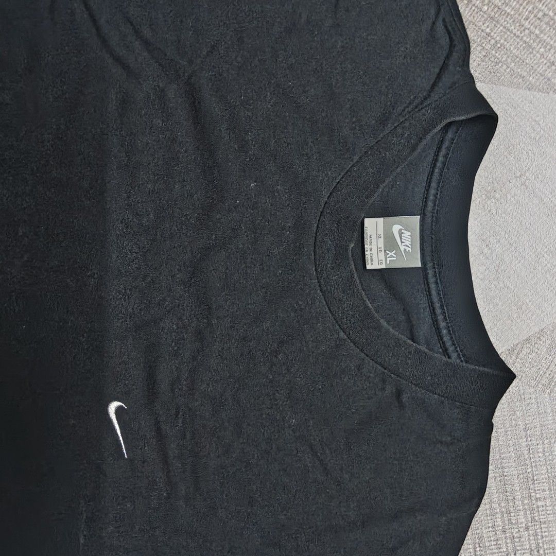 Nike Black T-Shirt XL (Category: Tshirts & Polo Shirts ) located in Manila. Submitted by charleshustla (Listing ID 1470291555, Image 2). Description: - Brand: Nike - Color: Classic Black - Size: XL (Standard fit) - Design: Small embroidered white swoosh logo on the left chest - Details: Ribbed crew neck collar - Origin: Made in China - Condition: Great for everyday wear and casual styling.