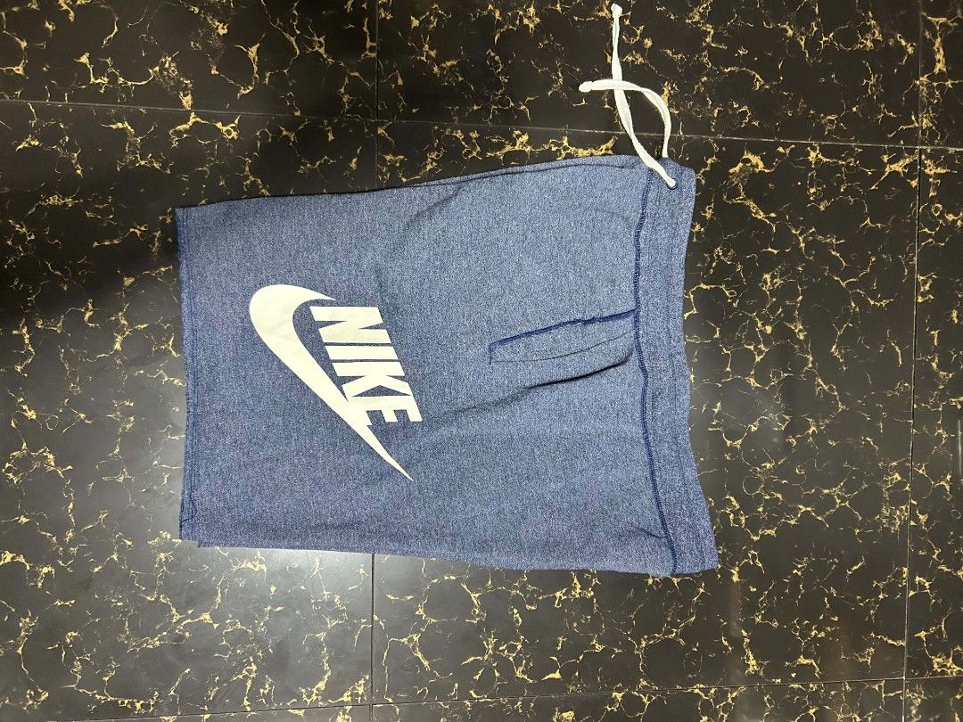 Nike Blue Heathered Shorts XL (Category: Shorts) located in Manila. Submitted by marjoriete27817 (Listing ID 1470310369, Image 2). Description: - Brand: Nike - Size: XL -waist line 36 length 20.5 - Color/Style: Blue heathered fleece - Material: Cotton and lyocell blend - Features: Drawstring waistband, side pockets - Condition: Minor cracking on the white Nike logo near the tail end of the swoosh - Origin: Made in Thailand.