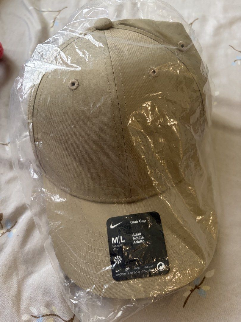 Nike Club Cap (Category: Caps & Hats) located in Mandaluyong City. Submitted by icheeellee (Listing ID 1470157057, Image 2). Description: - Brand: Nike Club Cap - Color: Tan beige - Size: M/L (Adult Unisex) - Condition: Brand new, never worn, still sealed in original plastic packaging - Details: Classic unstructured design, curved brim, embroidered eyelets, store tag attached.