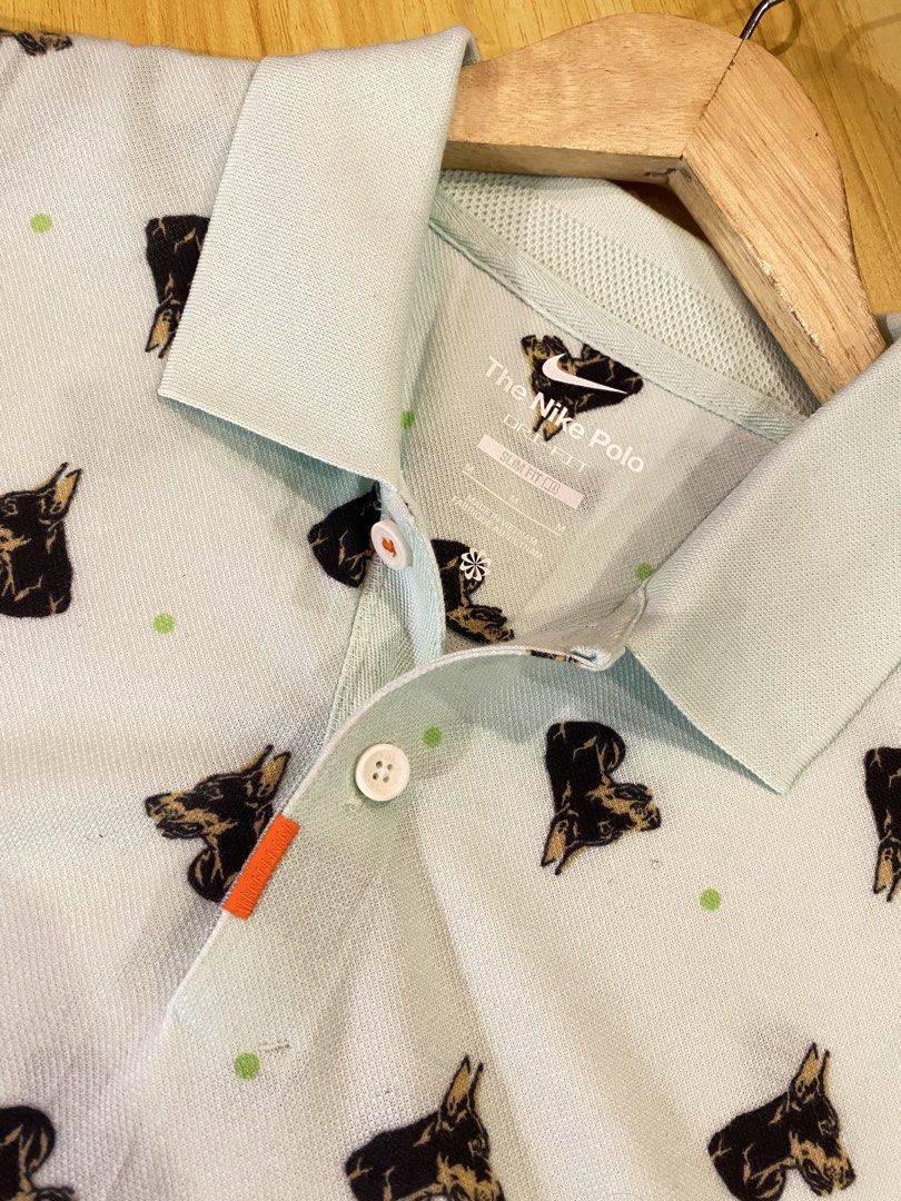 Nike Dri-FIT Slim Fit Doberman (Category: Tshirts & Polo Shirts ) located in Manila. Submitted by thriftvibes324 (Listing ID 1470244071, Image 2). Description: - Brand: Nike - Style: Slim fit polo with Doberman dog print and green dot pattern - Color: Light blue - Size: M - Material/Tech: Dri-FIT fabric to keep you dry - Details: Standard collar with 2 buttons, orange side tab - Style Code: DQ4577-379 - Condition: Clean and well-kept.