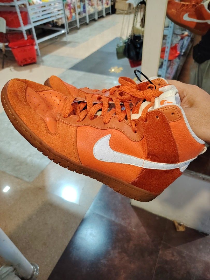 Negotiable! Nike Dunk High Orange Sneakers (Category: Sneakers) located in Las Pinas. Submitted by aiigoo (Listing ID 1470313272, Image 1). Description: NEGOTIABLE!!! - Brand: Nike - Style: High-top basketball sneakers - Color: Bright orange with white swoosh branding - Material: Suede and leather overlays - Features: Contrast patterned insole with Nike logo and thick rubber sole for traction - Closure: Standard lace-up front with matching orange