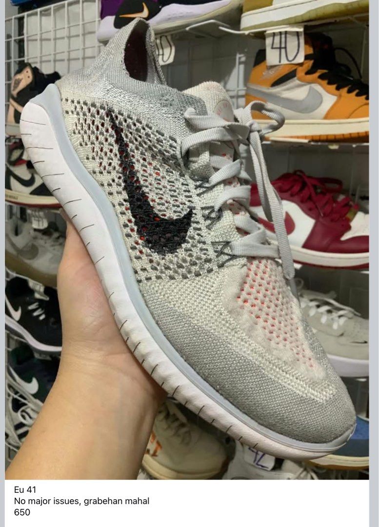 Nike Free RN Flyknit 2018 (Category: Sneakers) located in Caloocan City. Submitted by Twinsters_2nd (Listing ID 1470250106, Image 1). Description: - Brand: Nike Free RN Flyknit 2018 - Color: Grey woven upper with black swoosh and orange knit accents - Sole: Flexible white sole - Size: EU 41 - Condition: Excellent, no major flaws or heavy wear - Best for: Daily running or casual walking - payment first, sh0pee checkout - loc: Camarin, Caloocan.