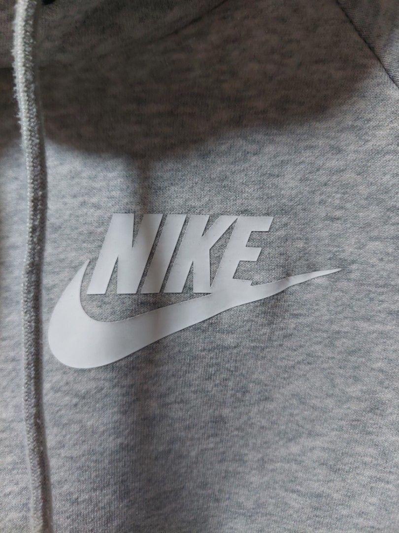 Nike Grey Hoodie Size S (Category: Hoodies) located in Quezon City. Submitted by jutang21 (Listing ID 1470282463, Image 2). Description: -10/10 Condition -Size small - Brand: Nike - Color: Grey with white logo - Size: S (tag on collar) - Material: Comfortable fleece inside - Features: Front pocket, drawstring hood - Condition: Clean tags attached, made in China.