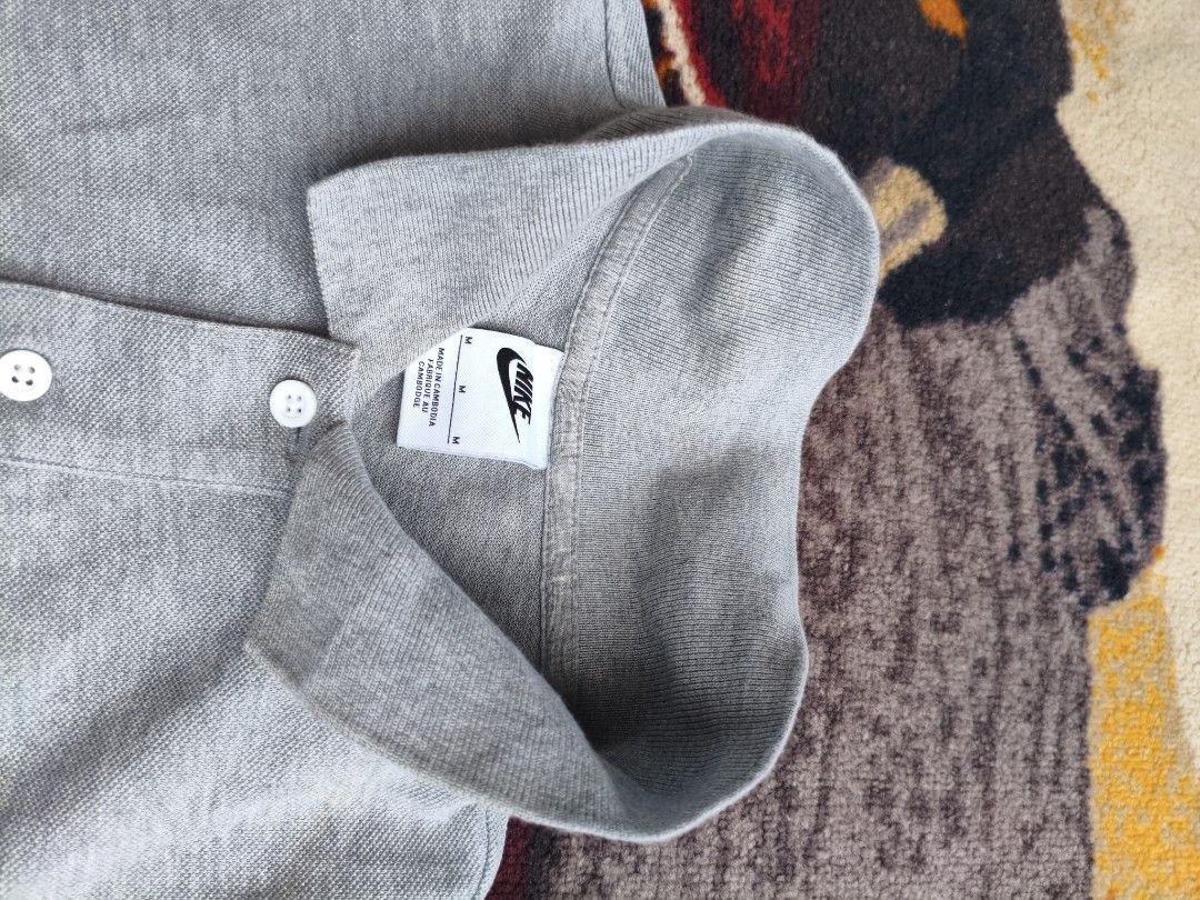 Nike Grey Polo Shirt Size M (Category: Tshirts & Polo Shirts ) located in Davao. Submitted by simonandre53791 (Listing ID 1470253602, Image 3). Description: - Brand: Nike - Item: Men's Polo Shirt - Color: Grey with embroidered white logo - Size: Medium - Material: 100% Cotton (soft and comfortable) - Details: Short sleeves, classic collar, two-button placket - Origin: Made in Cambodia - Condition: Clean, well-kept, ready to wear.