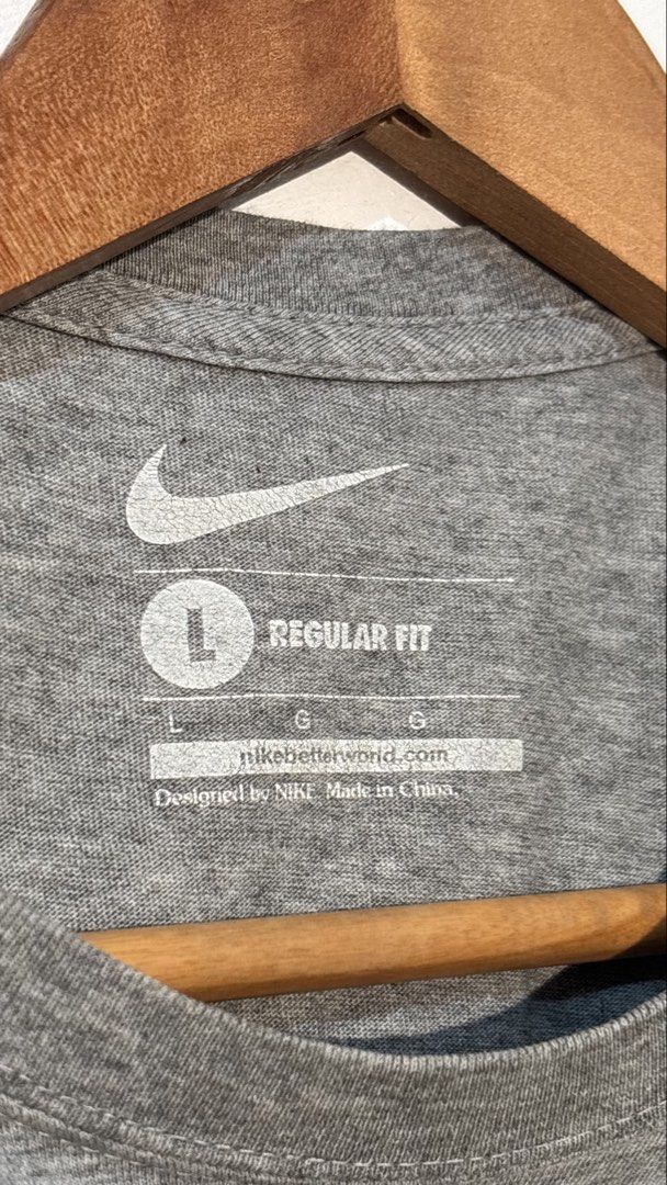 Nike Just Do It Grey T-shirt (Category: Tshirts & Polo Shirts ) located in Manila. Submitted by glano (Listing ID 1470299598, Image 3). Description: - Brand: Nike - Color: Grey with orange swoosh and black 'Just Do It' lettering - Size: Large (Regular fit) - Material: Soft and comfortable cotton blend - Details: Printed inner neck label with nikebetterworld.com - Ideal for: Everyday casual wear or workouts.