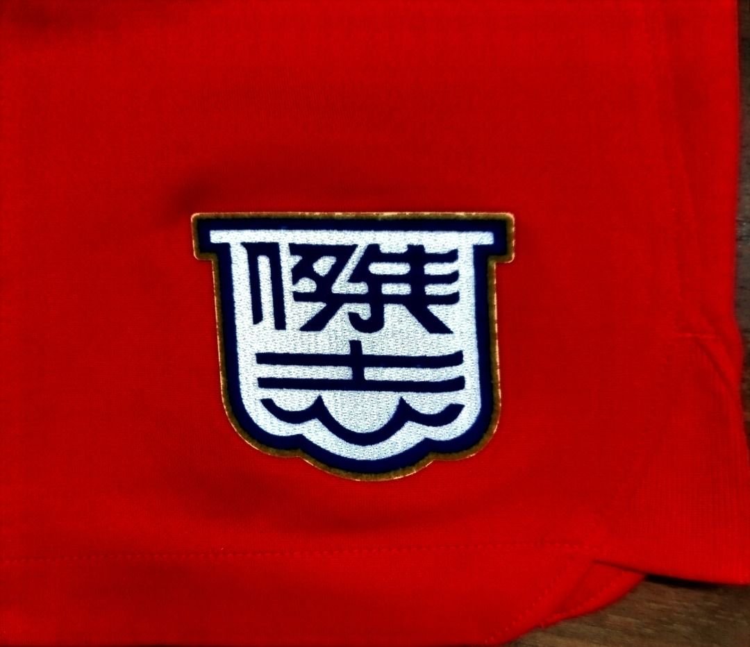 Nike Kitchee Kowloon Shorts Number 6 with Crest (Category: Shorts) located in Caloocan City. Submitted by safebear_4bdc70 (Listing ID 1470284266, Image 2). Description: Bright red Nike sports shorts with an elastic drawstring waistband. Large number 6 printed on the right leg above a small Swoosh logo. Embroidered crest patch on the left leg featuring blue and white Chinese characters inside a shield border. Lightweight polyester fabric. Clean st