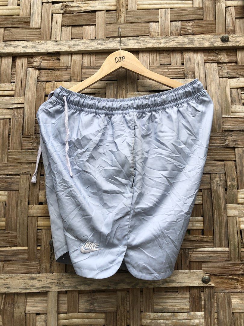 Nike Light Blue Nylon Athletic Shorts (Category: Shorts) located in Digos. Submitted by villasurdajayvee (Listing ID 1470221771, Image 2). Description: - Brand: Nike - Color: Light Blue - Size: XL - Condition: Great casual or workout piece - Material: Lightweight fabric with breathable inner mesh lining - Features: Elastic waistband with branded white drawstring, two side pockets, and embroidered Nike logo near the hem - Origin: Made in China.