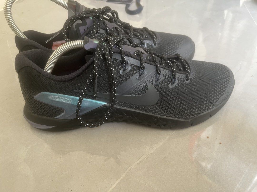Nike Metcon 4 Black Training Shoes (Category: Sneakers) located in Bulacan. Submitted by jhemieee (Listing ID 1470189709, Image 2). Description: - Brand/Model: Nike Metcon 4 training shoes - Size US 11 - Color: Black with iridescent heel accents and patterned laces - Features: Bright orange insoles with intact material tags, durable rubber outsoles - Condition: Clean pair, good tread condition underneath - Ideal for: Cross-training and gym workou