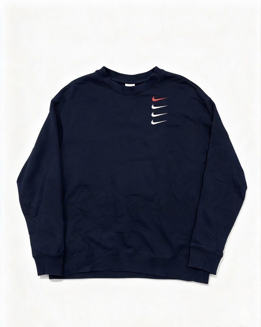 Nike Multi Swoosh Navy Sweatshirt (Category: Coats, Jackets and Outerwear) located in Caloocan City. Submitted by jerichotad22965 (Listing ID 1470194457, Image 1). Description: - Brand: Nike - Color: Navy blue with red and white stacked multi-swoosh embroidery - Size: XL (Standard fit) - Material: 88% cotton, 12% polyester blend - Details: Ribbed crewneck, cuffs, and hem - Condition: Excellent, PM for inquiries!.