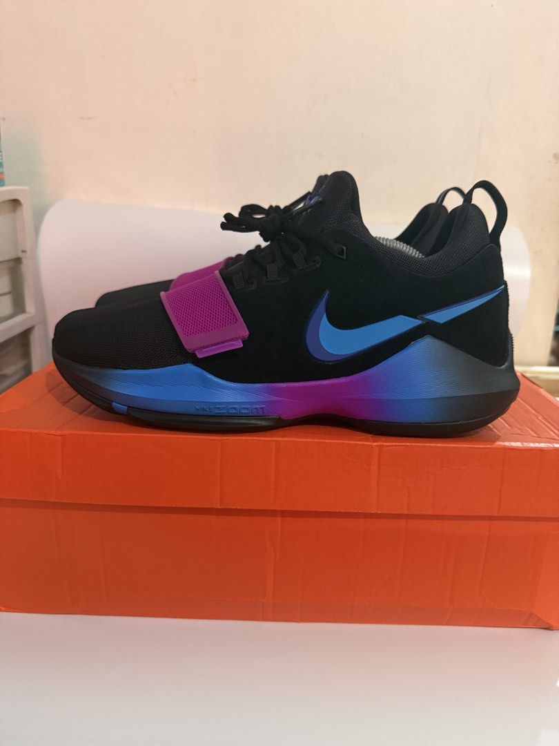 Nike PG 1 retro (Category: Sneakers) located in Pasay City. Submitted by ellianapenelope (Listing ID 1470206268, Image 1). Description: - Model: Nike PG 1 Signature Basketball Shoes - Colorway: Black with bright purple and blue accents - Support: Secure midfoot strap across the forefoot - Cushioning: Responsive Nike Zoom sole for comfort on and off the court - Details: Number 13 molded into the heel counter - Inclusions: Original orange Nike shoe
