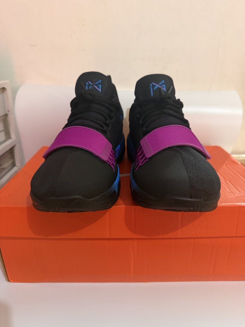Nike PG 1 retro (Category: Sneakers) located in Pasay City. Submitted by ellianapenelope (Listing ID 1470206268, Image 2). Description: - Model: Nike PG 1 Signature Basketball Shoes - Colorway: Black with bright purple and blue accents - Support: Secure midfoot strap across the forefoot - Cushioning: Responsive Nike Zoom sole for comfort on and off the court - Details: Number 13 molded into the heel counter - Inclusions: Original orange Nike shoe