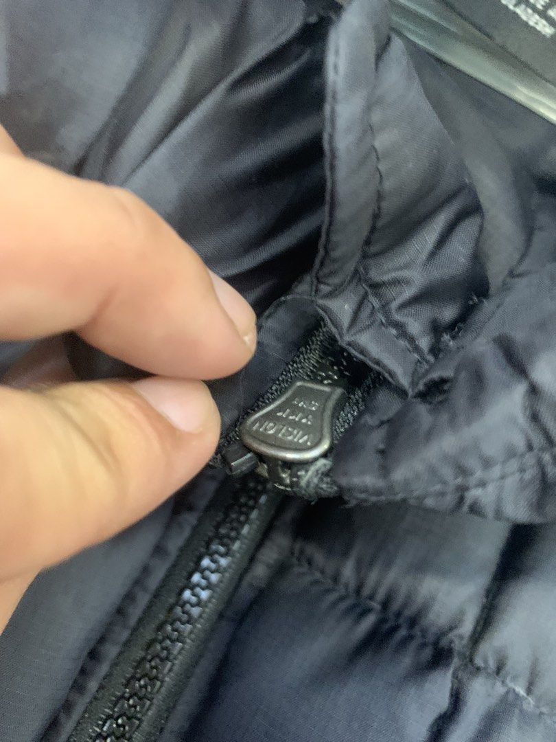 Nike Puffer Jacket Black with Orange Swoosh (Category: Coats, Jackets and Outerwear) located in Tarlac. Submitted by luxurious_apparel (Listing ID 1470265718, Image 3). Description: - Authentic Nike puffer jacket in classic black - Eye-catching bright orange embroidered swoosh logo on the chest - Stylish and warm quilted square stitching - Stand collar and full-zip front closure for extra protection - Two convenient zippered front pockets - Ribbe
