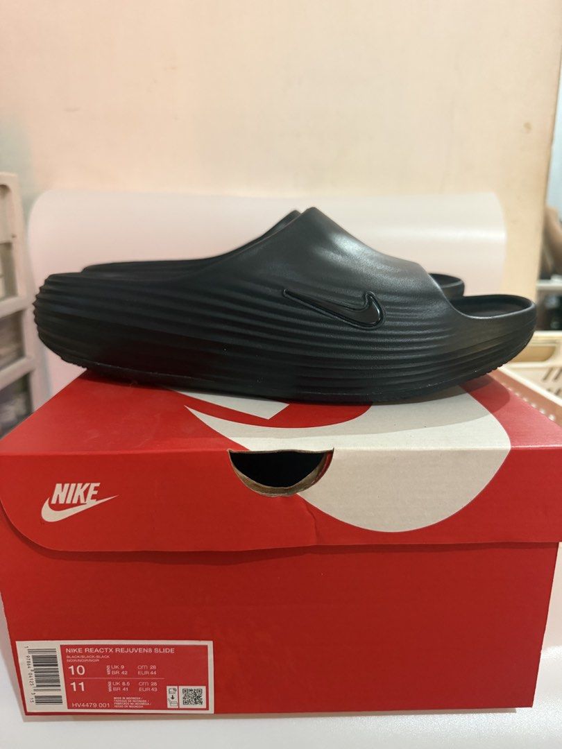 Nike ReactX Rejuven8 Slide Black Size 10 (Category: Slippers & Slides) located in Pasay City. Submitted by ellianapenelope (Listing ID 1470206832, Image 3). Description: - Item: Nike ReactX Rejuven8 Slides - Color: Black - Size: Men's US 10 / Women's US 11 - Condition: Brand new with original red and white Nike box - Comfort: Highly cushioned footbed with signature ReactX branding - Traction: Wavy textured sole underneath for enhanced grip - Perf