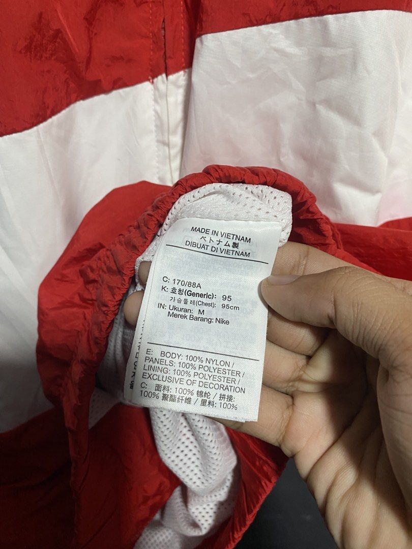 Nike Red White Swoosh Windbreaker Jacket (Category: Coats, Jackets and Outerwear) located in Antipolo. Submitted by drop.thrifts (Listing ID 1470242889, Image 3). Description: - Brand: Nike - Item: Red windbreaker jacket with iconic huge white swoosh across front and sleeves - Size: M (Regular fit) - Material: 100% Nylon body, 100% Polyester panels and mesh lining - Origin: Made in Vietnam - Features: Full zip closure, high collar, breathable mes