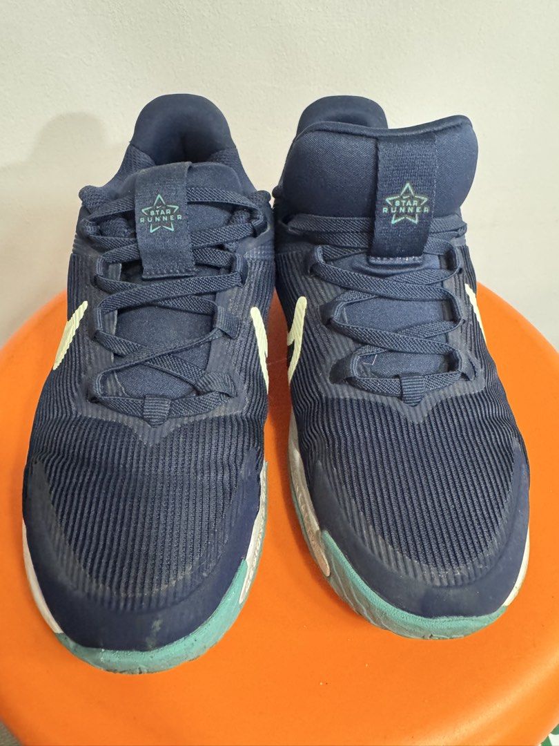 Nike Star Runner 04 Navy Blue Sneakers (Category: Babies & Kids Fashion) located in Valenzuela. Submitted by sofiasticated.decluttering (Listing ID 1470168234, Image 2). Description: - Brand: Nike Star Runner 4 - Size: US 2 /EU 33.5 - Color: Navy blue with light green accents and swoosh - Features: Star Runner logo text on tongue and heel pull tabs, white midsole, teal outsole - Condition: Worn a few times, uppers hold shape very well, normal dir