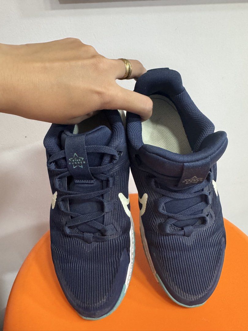 Nike Star Runner 04 Navy Blue Sneakers (Category: Babies & Kids Fashion) located in Valenzuela. Submitted by sofiasticated.decluttering (Listing ID 1470168234, Image 3). Description: - Brand: Nike Star Runner 4 - Size: US 2 /EU 33.5 - Color: Navy blue with light green accents and swoosh - Features: Star Runner logo text on tongue and heel pull tabs, white midsole, teal outsole - Condition: Worn a few times, uppers hold shape very well, normal dir