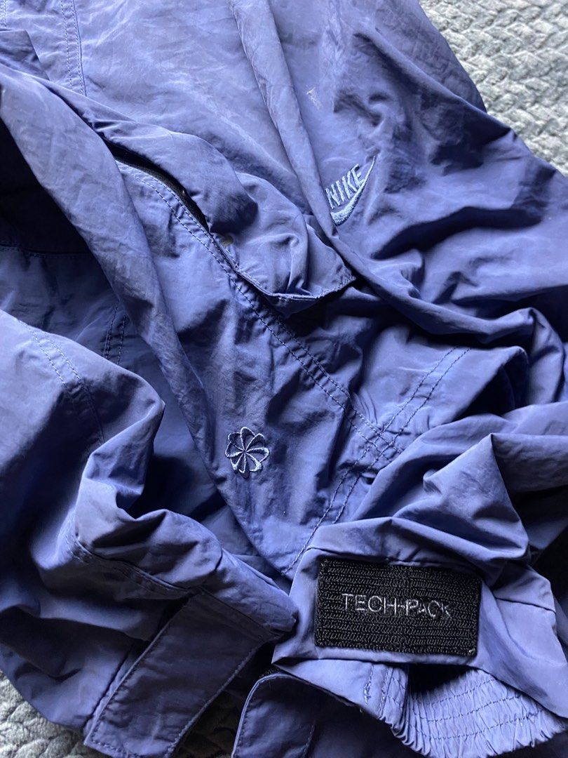 Nike Tech Pack Purple Hooded Utility Jacket (Category: Coats, Jackets and Outerwear) located in Olongapo. Submitted by WAVYT (Listing ID 1470319307, Image 2). Description: - Brand/Model: Authentic Nike Tech Pack Utility Jacket - Color: Cool washed purple shade - Material: Lightweight and comfortable - Storage: Multiple functional cargo pockets on the front and back - Cuffs: Adjustable Velcro straps for a custom fit - Hood: Features stylish strap 
