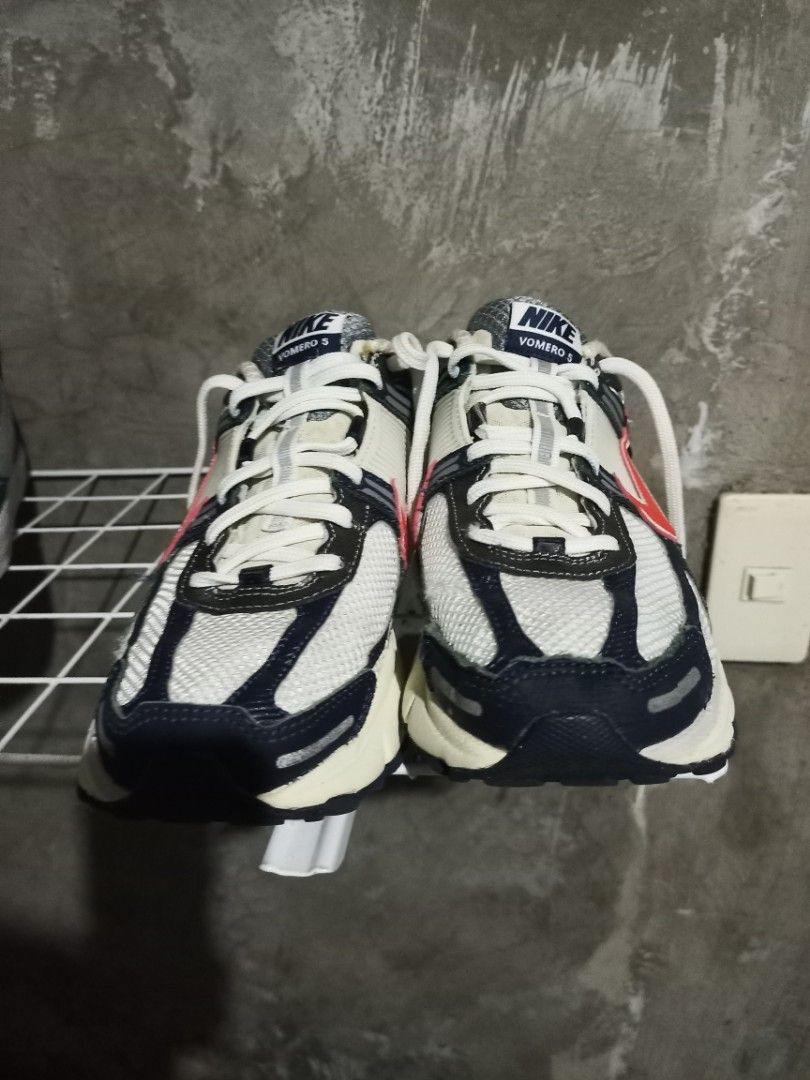 Nike Vomero 5 White Red Blue (Category: Sneakers) located in Mabalacat. Submitted by hasashoe (Listing ID 1470280746, Image 2). Description: - Brand: Nike Vomero 5 - Colorway: White with red and navy blue accents - Style: Chunky retro runner with mesh upper and cage overlays - Comfort & Grip: Cushlon foam midsole and durable rubber outsole - Condition: Great everyday pair, clean outsoles, and minimal wear on treads - Inclusions: Comes with origin