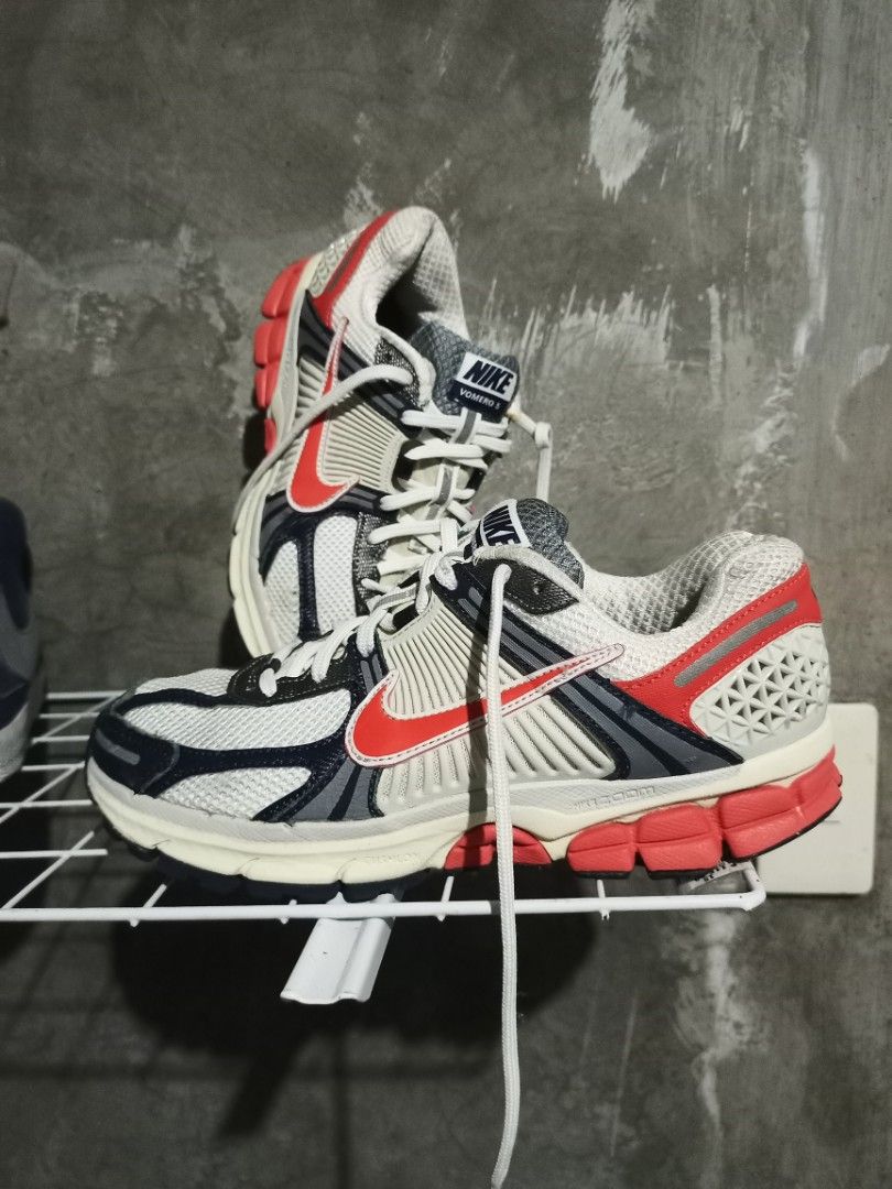 Nike Vomero 5 White Red Blue (Category: Sneakers) located in Mabalacat. Submitted by hasashoe (Listing ID 1470280746, Image 1). Description: - Brand: Nike Vomero 5 - Colorway: White with red and navy blue accents - Style: Chunky retro runner with mesh upper and cage overlays - Comfort & Grip: Cushlon foam midsole and durable rubber outsole - Condition: Great everyday pair, clean outsoles, and minimal wear on treads - Inclusions: Comes with origin