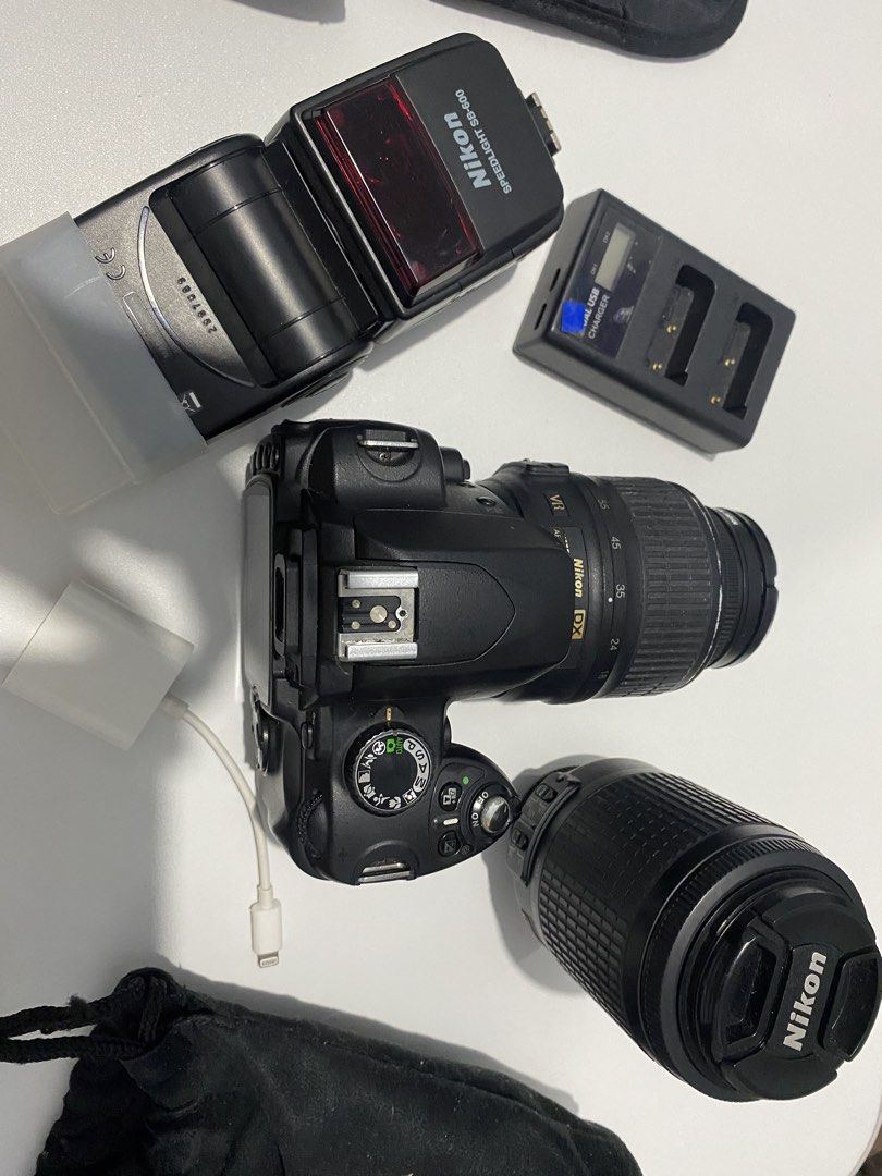 Nikon DSLR Camera Bundle with Lenses and Flash (Category: Cameras) located in Manila. Submitted by venicezam20 (Listing ID 1470254904, Image 3). Description: - Complete Nikon DX camera setup, ready for use - Includes two versatile lenses - Nikon Speedlight SB-600 flash with soft diffuser included - Dual USB battery charger with charging cable - Two protective pouches for safe storage - Screen powers on and functions normally - Compact kit that pa