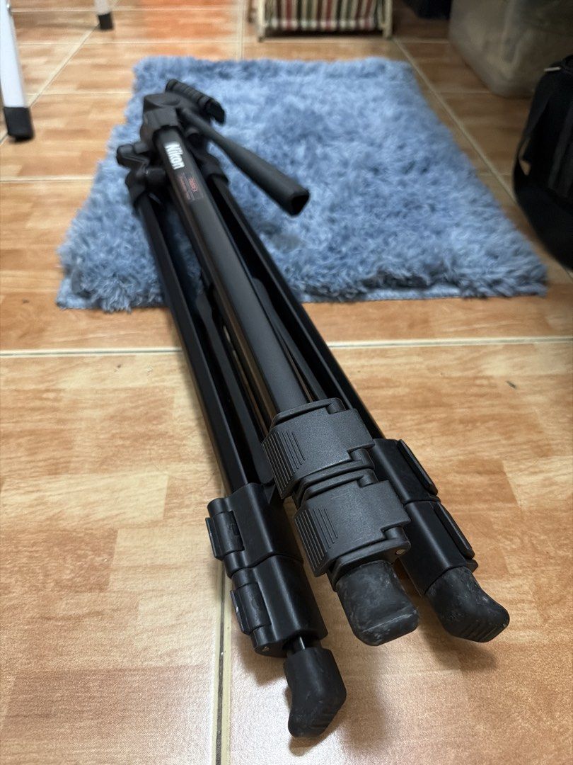 Nikon T600EX Photo & Video Tripod (Category: Tripods & Monopods) located in Pasig City. Submitted by yemaayen (Listing ID 1470179910, Image 2). Description: - Brand/Model: Nikon T600EX Photo & Video Tripod (Black) - Head: Smooth pan-and-tilt head for steady shots and video work - Build: Sturdy construction with extendable legs - Inclusion: Original black carrying case with zipper closure - Condition: Fully functional, never been used - slightly n