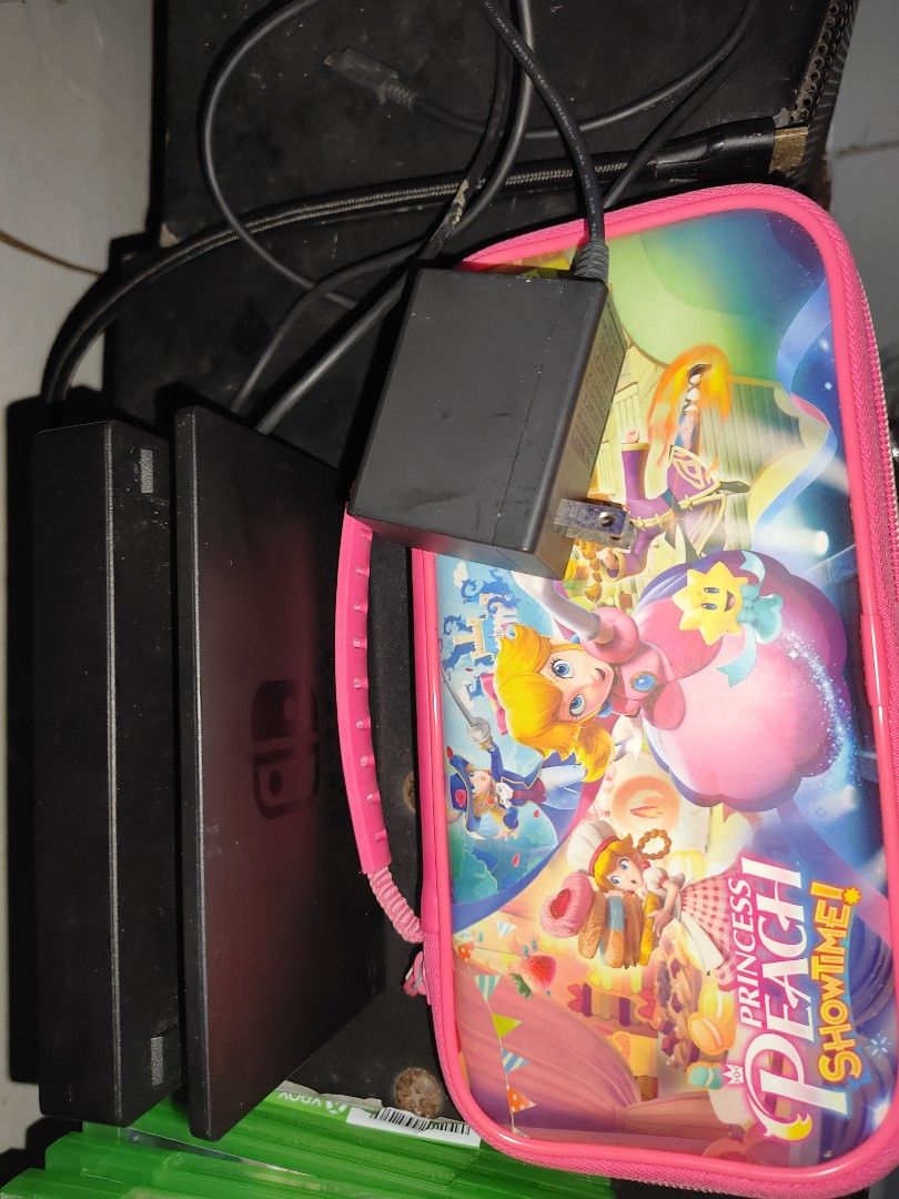Nintendo Switch Console with Games and Case (Category: Nintendo) located in Manila. Submitted by adr14nbati25392 (Listing ID 1470172577, Image 2). Description: - Nintendo Switch console (powers up normally) - Complete with dock and power adapter - Includes adorable Princess Peach themed carrying case - Game cartridges included: Mario Kart 8 Deluxe and Princess Peach Showtime - Great ready-to-play portable gaming bundle.