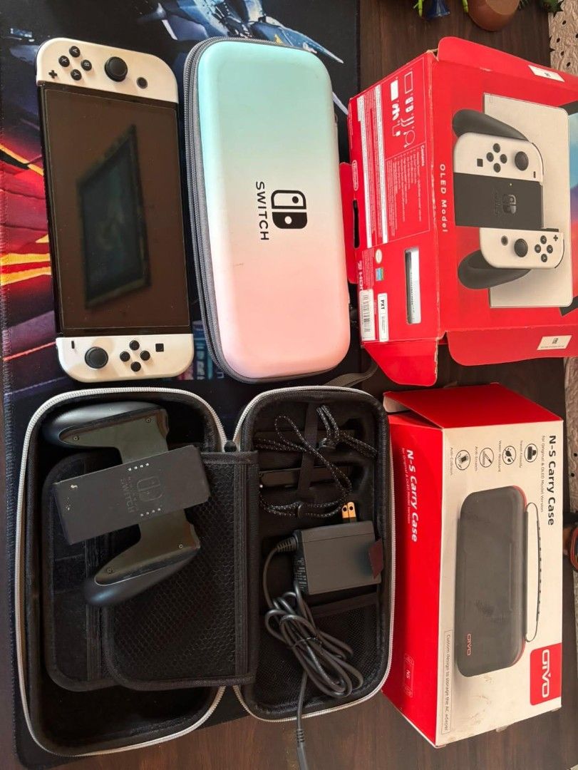 Nintendo Switch OLED Model White with Carrying Case (Category: Nintendo) located in Manila. Submitted by fast_chaeberry (Listing ID 1470179147, Image 1). Description: - Item: Nintendo Switch OLED Model (White) - Condition: Fully working, minor wear on the original box - Includes: Original box, charger, grip controller attachment, and standard Joy-Cons - Freebies: 2 carrying cases (1 gradient, 1 black) - Ideal for your next gaming setup!.