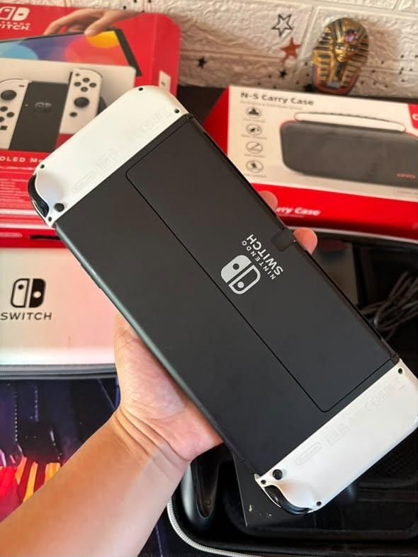 Nintendo Switch OLED Model White with Carrying Case (Category: Nintendo) located in Manila. Submitted by fast_chaeberry (Listing ID 1470179147, Image 2). Description: - Item: Nintendo Switch OLED Model (White) - Condition: Fully working, minor wear on the original box - Includes: Original box, charger, grip controller attachment, and standard Joy-Cons - Freebies: 2 carrying cases (1 gradient, 1 black) - Ideal for your next gaming setup!.