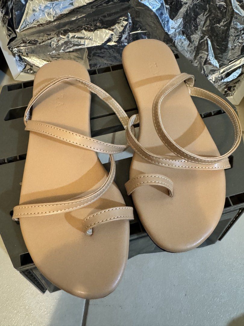 Nude Strappy Flat Sandals (Category: Flats & Sandals) located in Makati City. Submitted by shop2nds (Listing ID 1470242775, Image 3). Description: - Style: Nude strappy flat sandals with a trendy toe loop design - Fit: Easy slip-on style, perfect for everyday casual walks - Color: Versatile neutral beige that matches any summer outfit - Condition: Clean soles with minimal signs of wear.