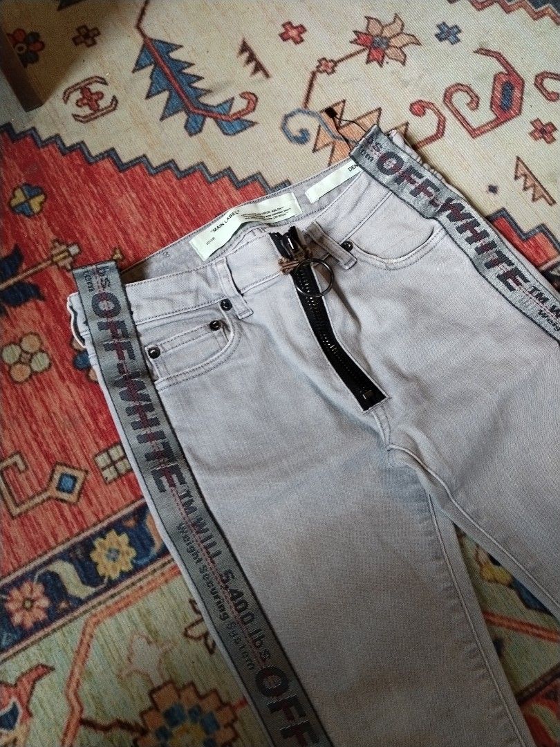 Off-White Grey Denim Embroidered Arrows (Category: Jeans) located in Pasig City. Submitted by loveforlux_2025 (Listing ID 1470237141, Image 2). Description: - Brand: Off-White -25 to 26 waist - Collection: 2013 (Main label verified) - Style: Grey skinny denim jeans / Slim fit - Details: Iconic industrial strap lettering down legs, glitter diagonal stripes on back ankles - Hardware: Exposed front zipper with ring pull, hook-and-eye waist closure -