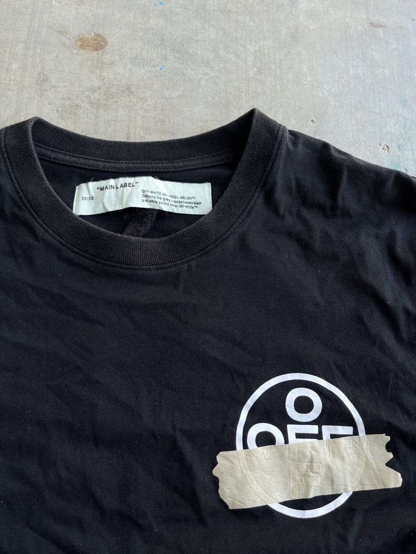 Off-White Tape Arrow Black T-Shirt (Category: Tshirts & Polo Shirts ) located in Dipaculao. Submitted by _jzx.ph4lxfe (Listing ID 1470215266, Image 3). Description: - Brand: Off-White - Color: Black - Material: Premium Cotton for breathable everyday wear - Design: Iconic tape arrow graphic on the back and taped circle logo on the front chest - Fit: Classic short sleeve crewneck - Details: Includes official main collar label and diagonal stripe ca