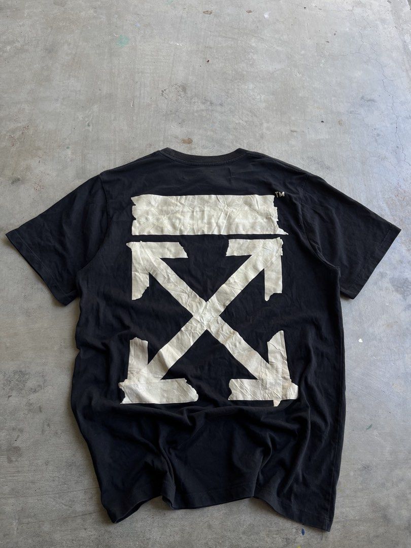 Off-White Tape Arrow Black T-Shirt (Category: Tshirts & Polo Shirts ) located in Dipaculao. Submitted by _jzx.ph4lxfe (Listing ID 1470215266, Image 2). Description: - Brand: Off-White - Color: Black - Material: Premium Cotton for breathable everyday wear - Design: Iconic tape arrow graphic on the back and taped circle logo on the front chest - Fit: Classic short sleeve crewneck - Details: Includes official main collar label and diagonal stripe ca