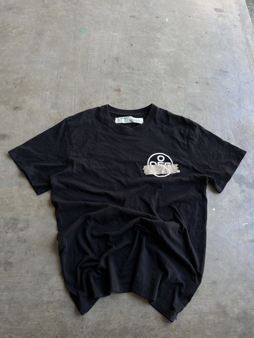 Off-White Tape Arrow Black T-Shirt (Category: Tshirts & Polo Shirts ) located in Dipaculao. Submitted by _jzx.ph4lxfe (Listing ID 1470215266, Image 1). Description: - Brand: Off-White - Color: Black - Material: Premium Cotton for breathable everyday wear - Design: Iconic tape arrow graphic on the back and taped circle logo on the front chest - Fit: Classic short sleeve crewneck - Details: Includes official main collar label and diagonal stripe ca