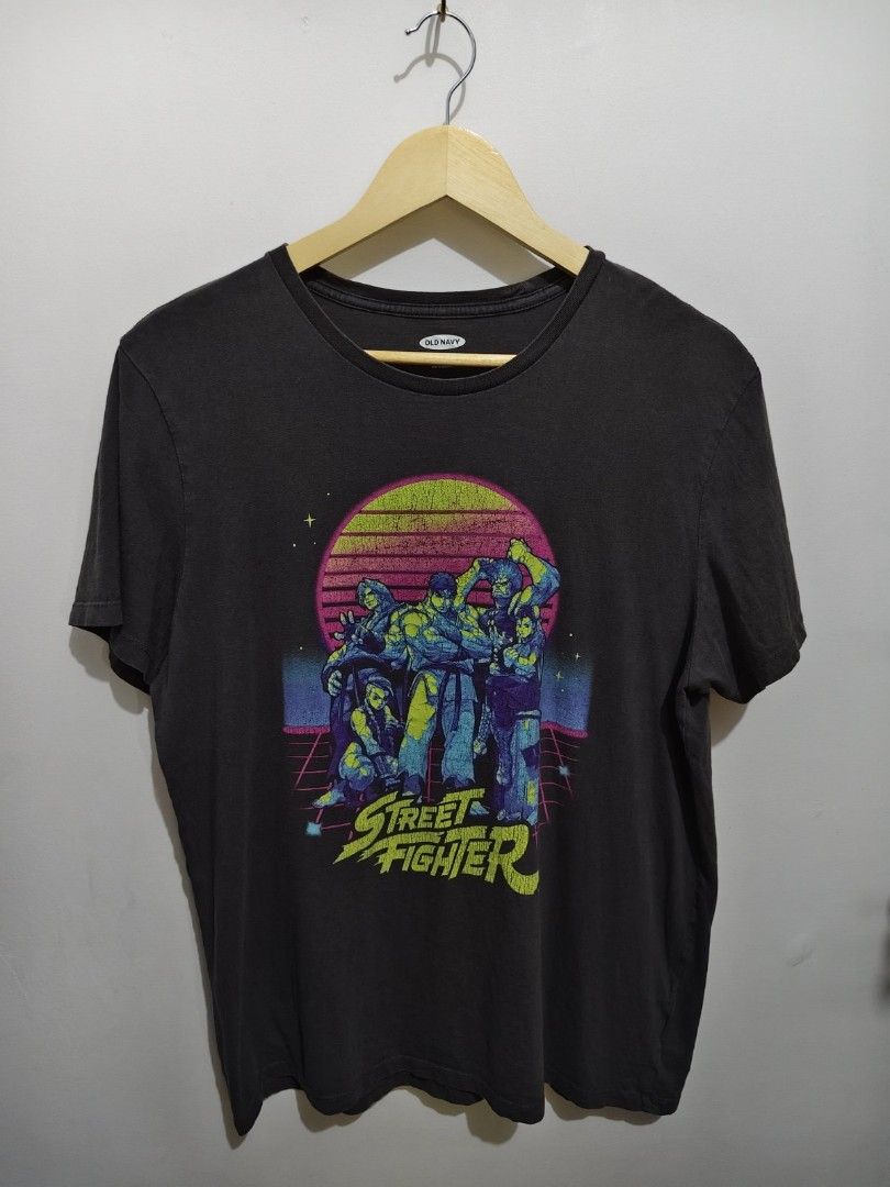Old Navy Street Fighter Graphic Tee Size L (Category: Tshirts & Polo Shirts ) located in Manila. Submitted by icesummer.onlineshop (Listing ID 1470154257, Image 1). Description: - Brand: Old Navy - Item: Street Fighter Graphic T-Shirt - Color: Grey - Size: Large - Design: Classic Street Fighter characters with retro synthwave sunset background and intentional vintage crackle texture - Details: short sleeves - Origin: Made in Nicaragua (Production