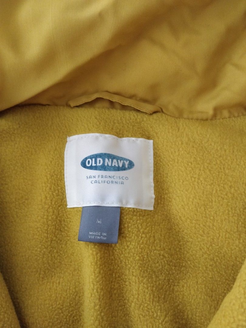 Old Navy Yellow Puffer Vest Size M (Category: Sleeveless) located in Marikina City. Submitted by rusellej (Listing ID 1470227228, Image 3). Description: - Brand/Model: Old Navy Puffer Vest - Color: Mustard Yellow - Size: Medium - Features: Full zip front, stand collar, front welt pockets - Lining: Warm fleece interior - First pic is only sample of similar style.