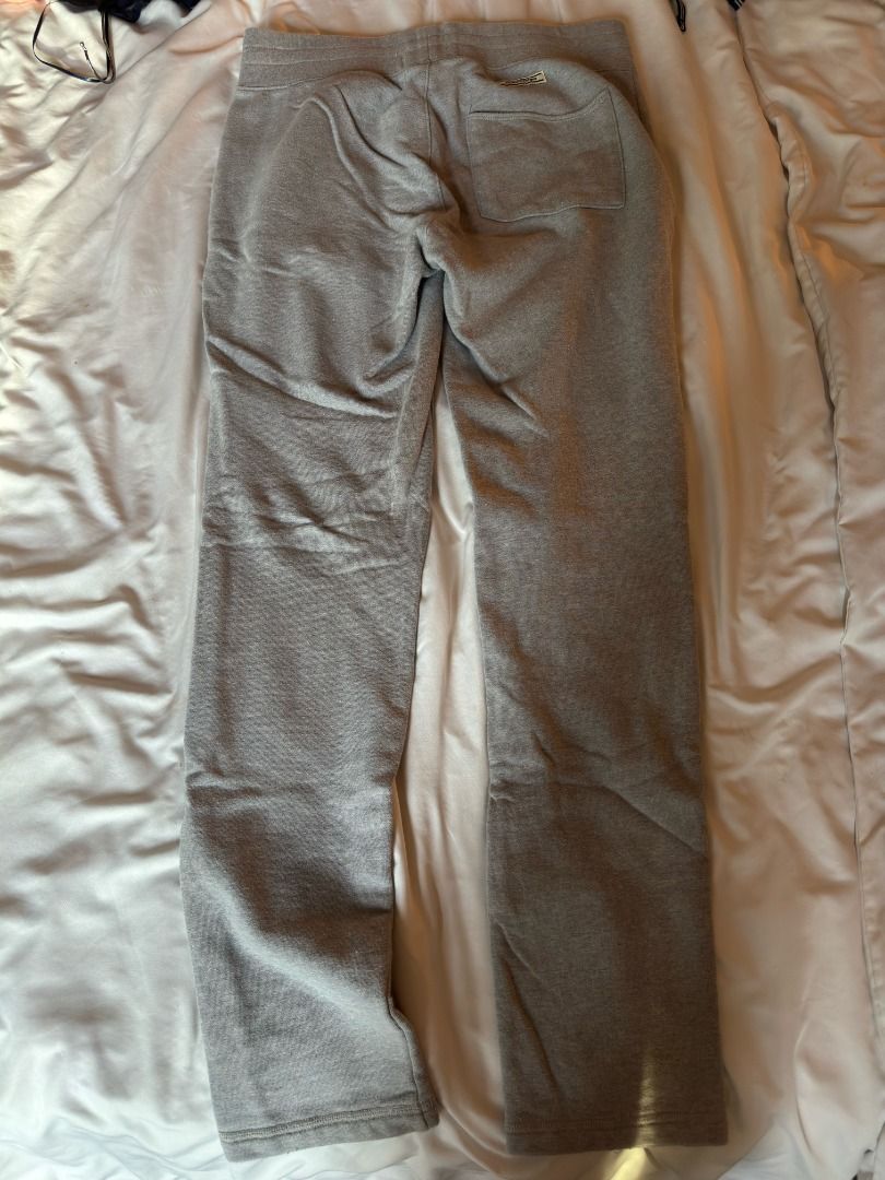 Onitsuka Tiger Grey Sweatpants Track Pants Medium (Category: Joggers) located in Cebu City. Submitted by _t.rix (Listing ID 1470181145, Image 2). Description: - Brand: Onitsuka Tiger - Color: Grey - Material: Soft sweatshirt fabric - Fit: Relaxed fit through the legs with a drawstring waistband - Details: Front center crease stitching and single back pocket - Condition: Clean overall, perfect for lounging or casual wear.