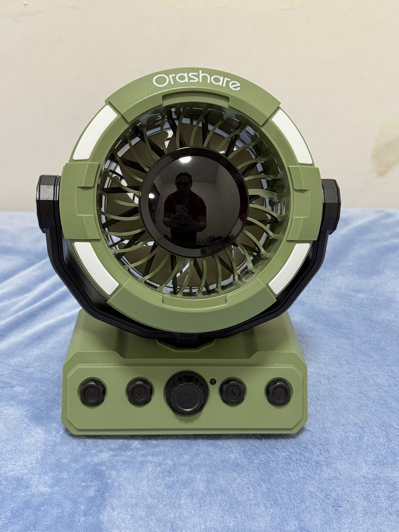 Orashare Portable Camping Fan DF09 Green (Category: Fans) located in Malolos. Submitted by jaizemndz22 (Listing ID 1470274105, Image 1). Description: - Model: Orashare DF09 Portable Camping Fan (Green) - Massive 20000mAh battery capacity for long-lasting use - 10W rated power with DC 5V 2A input - Built-in LED lights around the frame for illumination - Multi-function control buttons on a sturdy base - Adjustable tilt angle for precise airflow dir