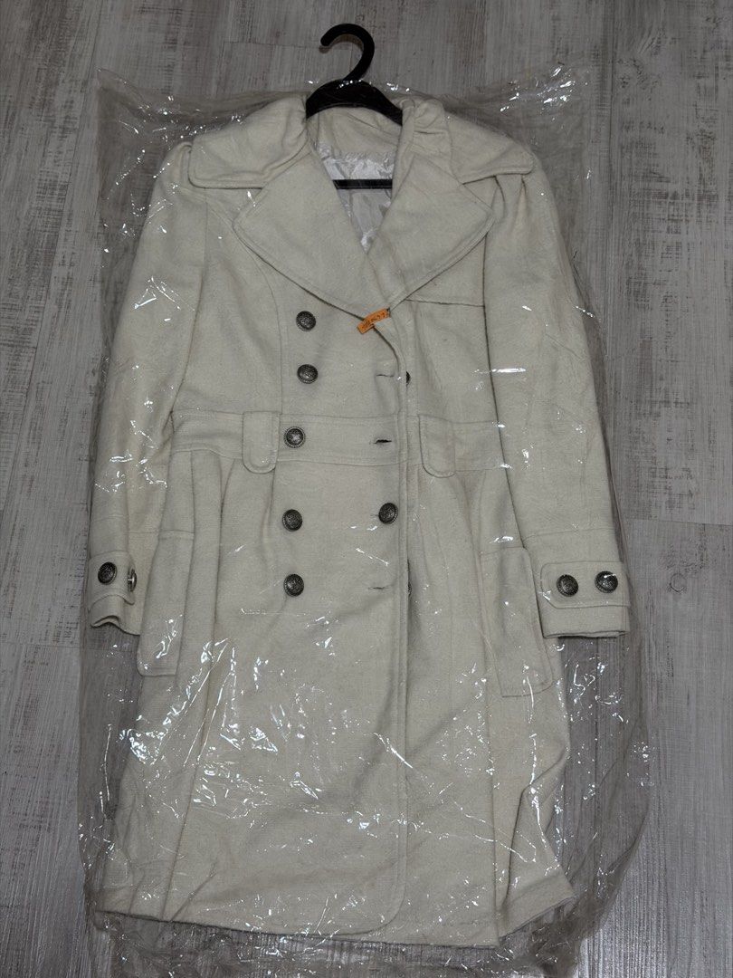 Outer jacket (Category: Coats, Jackets and Outerwear) located in Singapore. Submitted by bakerdad (Listing ID 1470206225, Image 2). Description: - Item: Women's winter outer jacket / trench coat - Color: Cream / Off-white - Size: L (EU 40 / UK 12 / US 8) - Design: Double-breasted button closure, wide lapels, waist belt detail - Condition: 7/10, carefully stored in protective plastic .