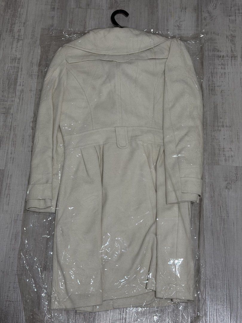 Outer jacket (Category: Coats, Jackets and Outerwear) located in Singapore. Submitted by bakerdad (Listing ID 1470206225, Image 1). Description: - Item: Women's winter outer jacket / trench coat - Color: Cream / Off-white - Size: L (EU 40 / UK 12 / US 8) - Design: Double-breasted button closure, wide lapels, waist belt detail - Condition: 7/10, carefully stored in protective plastic .