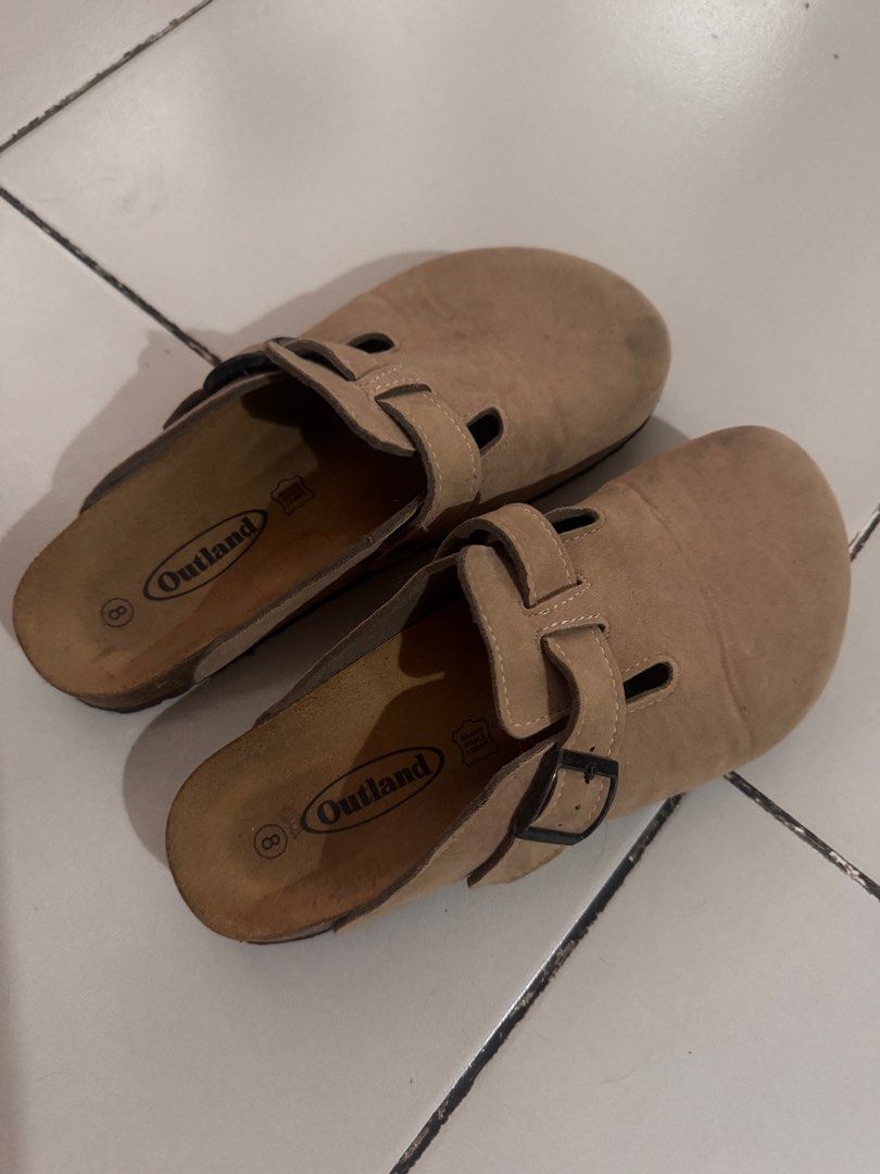 Outland Suede Clogs Sandals Size 8 Tan (Category: Slippers & Slides) located in Mandaluyong City. Submitted by spaceshipshop (Listing ID 1470265799, Image 1). Description: - Brand/Model: Outland Suede Clogs - Color: Tan - Size: 8 (marked on footbed) - Design: Slip-on with adjustable strap and black buckle - Material: Genuine leather lining with cork footbed.