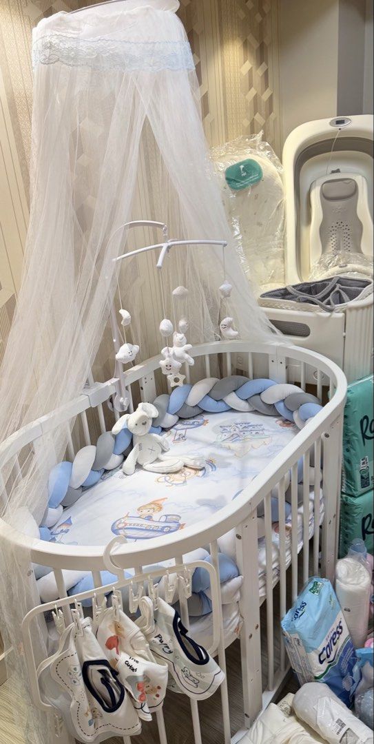 Oval/Round Baby Crib 9-in-1 multi-functional (Category: Children's Beds) located in Mandaluyong City. Submitted by itsmeangela.295 (Listing ID 1470226925, Image 1). Description: Letting go my son's crib. Barely used, my son's likes co-sleeping • Pure white wooden convertible frame with wheels. • Matching floor-length overhead mosquito net/canopy with its mounting pole. • Overhead cloud, star, and moon musical mobile arm. • Tri-color braided bumpe