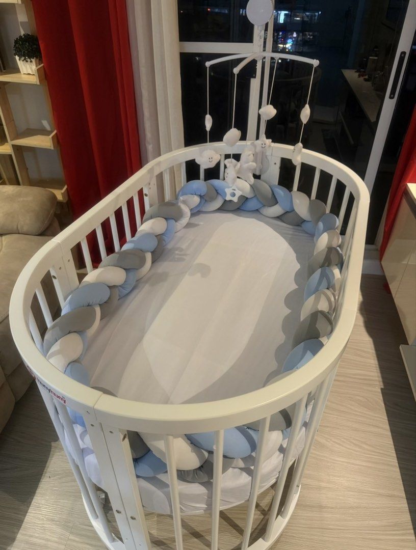 Oval/Round Baby Crib 9-in-1 multi-functional (Category: Children's Beds) located in Mandaluyong City. Submitted by itsmeangela.295 (Listing ID 1470226925, Image 3). Description: Letting go my son's crib. Barely used, my son's likes co-sleeping • Pure white wooden convertible frame with wheels. • Matching floor-length overhead mosquito net/canopy with its mounting pole. • Overhead cloud, star, and moon musical mobile arm. • Tri-color braided bumpe