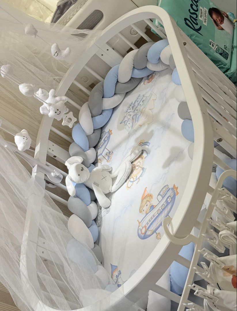 Oval/Round Baby Crib 9-in-1 multi-functional (Category: Children's Beds) located in Mandaluyong City. Submitted by itsmeangela.295 (Listing ID 1470226925, Image 2). Description: Letting go my son's crib. Barely used, my son's likes co-sleeping • Pure white wooden convertible frame with wheels. • Matching floor-length overhead mosquito net/canopy with its mounting pole. • Overhead cloud, star, and moon musical mobile arm. • Tri-color braided bumpe