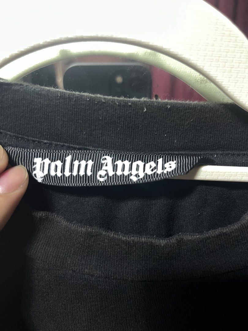 Palm Angels Crocodile Graphic Black Tee Size L (Category: Tshirts & Polo Shirts ) located in Iloilo. Submitted by cloud.thrifts (Listing ID 1470157345, Image 3). Description: - Brand: Palm Angels - Color: Black - Size: Large (L) - Material: 100% Cotton - Design: Severed crocodile graphic with logo on chest, large gothic logo on back - Details: Ribbed collar, straight hem, style code PMBB036F18441027 - Condition: Minor lint on collar ribbing, othe