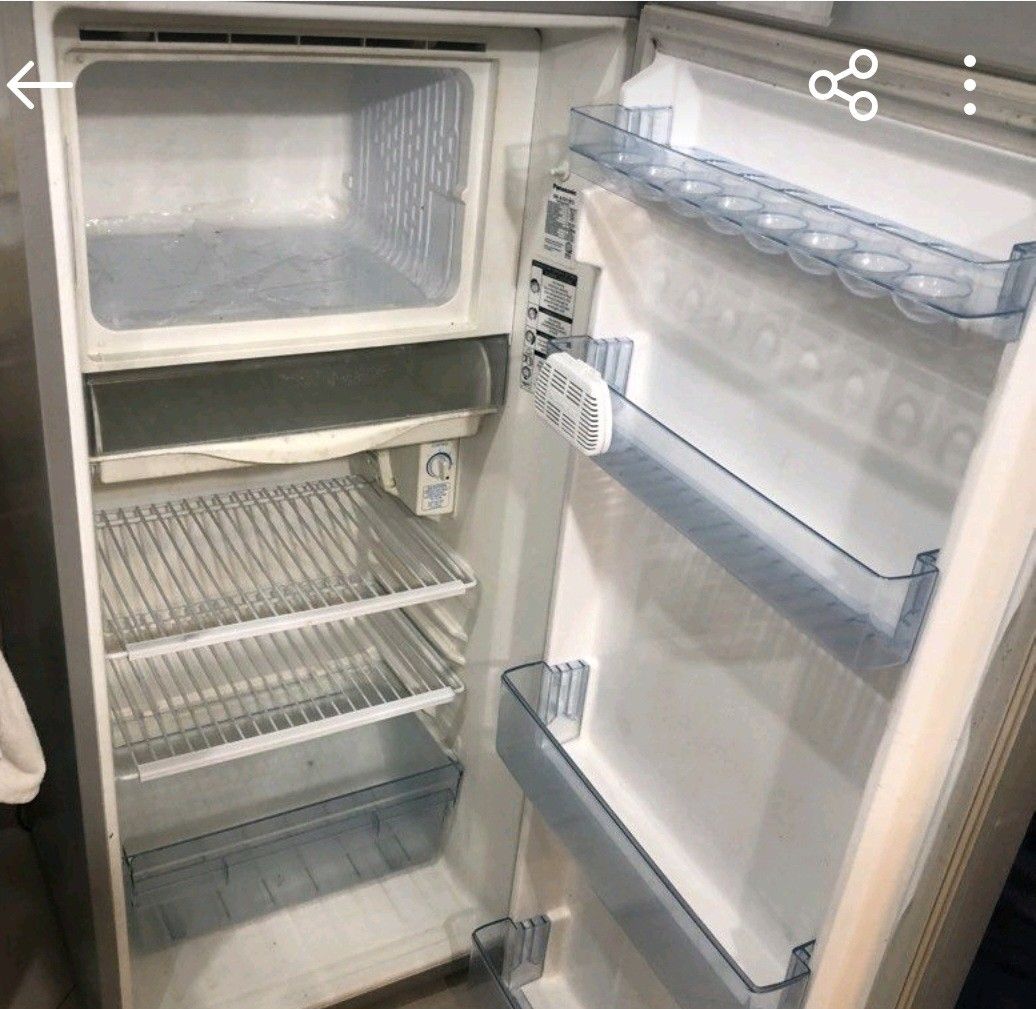 Panasonic Refrigerator Single Door Fridge (Category: Refrigerators and Freezers) located in Marilao. Submitted by marnie.il (Listing ID 1470261260, Image 1). Description: - Brand: Panasonic - Color: Grey finish - Layout: Top freezer compartment with clean interior - Features: Wire shelves, clear door bins, and bottom crisper drawer - Condition Note: Has a handwritten sign taped on front saying 'do not plug in' - Best Use: Great option for extra s