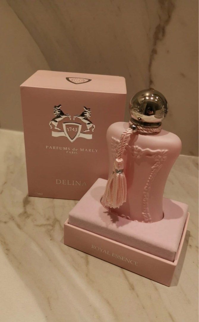 Parfums de Marly Delina Royal Essence 75ml (Category: Fragrance & Deodorants) located in Manila. Submitted by hannahjac (Listing ID 1470263700, Image 1). Description: - Brand: Parfums de Marly - Fragrance: Delina Eau de Parfum - Size: Full size 75ml bottle (sprayed 1-2 times for testing only) - Bottle: Matte pink glass with silver metallic cap and pink tassel - Inclusion: Complete with original presentation box and velvet-lined base - Condition: 