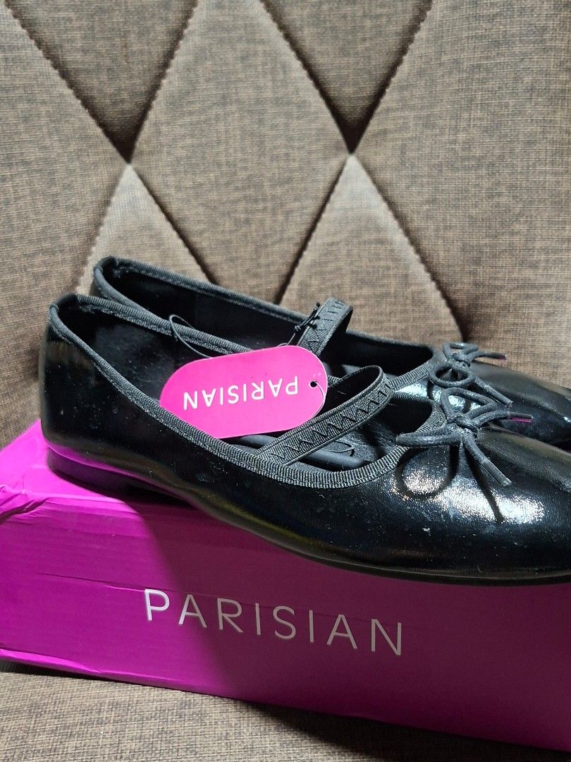 Parisian Black Bela Ballet Flats Size 9 (Category: Flats & Sandals) located in Makati City. Submitted by paudeclutters (Listing ID 1470280631, Image 2). Description: - Brand: Parisian (Model: Bela) - Color & Finish: Black with a glossy shine - Size: 9 - Details: Cute bow on top with a stylish strap across the foot - Condition: Brand new, never worn, with original - Packaging: Comes in the original pink Parisian shoebox - with signs of storage.