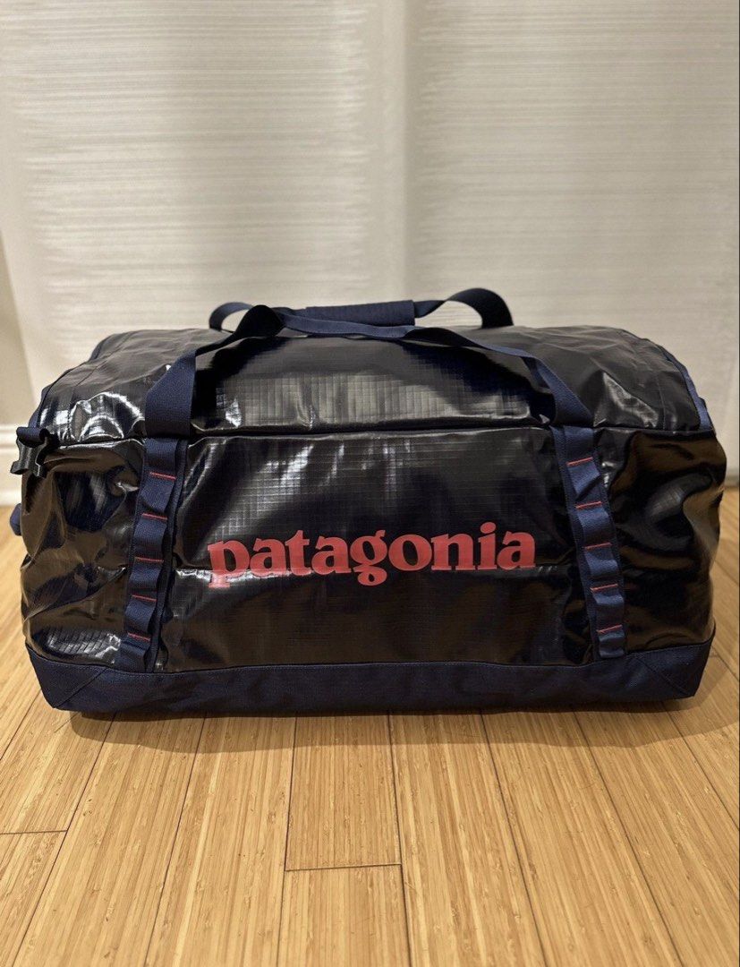 Patagonia Black Hole Duffle Bag (Category: Backpacks) located in Makati City. Submitted by cantstopshopping94 (Listing ID 1470211867, Image 3). Description: Patagonia Black Hole duffle bag in dark navy blue with red logo lettering. Heavy-duty water-resistant material. Zippered front pocket, sturdy carry handles, and daisy chain webbing on both sides. Generous capacity for travel, gym sessions, or weekend getaways. Packable design folds into its o