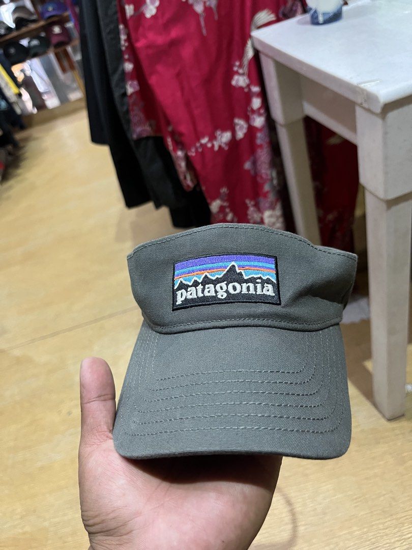 Patagonia Grey Visor Cap (Category: Caps & Hats) located in Tabuk. Submitted by collectors_thrift_shop (Listing ID 1470262204, Image 1). Description: - Brand: Patagonia - Color: Versatile grey - Design: Classic embroidered mountain logo patch on the front - Material: Sturdy, high-quality, and well-constructed fabric - Fit: Adjustable black strap with a secure plastic buckle closure - Condition: Clean brim with neat stitching details - Style: Perf